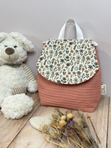 Sac à dos maternelle en double gaze fleuri sur le rabat et en nid d'abeille marsala pour le corps du sac.